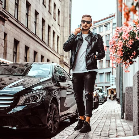 A rich guy next to a car